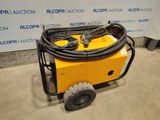 an image of a yellow machine with a hose attached to it