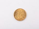 an image of a gold coin sitting on top of a white surface