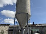 a large cement silo in the middle of a field