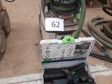 a box of tools sitting on the floor next to a machine