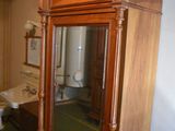 a wooden cabinet with a mirror on top of it