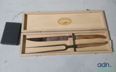 a wooden box with a knife and a brush in it