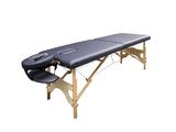 a black massage table sitting on top of a wooden table