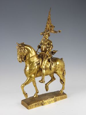 an antique bronze statue of a man on a horse with a hat on