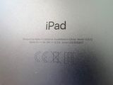 the back of an ipad sitting on top of a wooden table