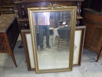 a man standing in front of a mirror in a room