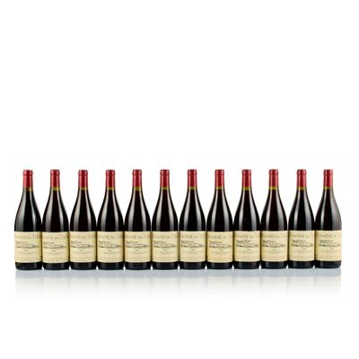 six bottles of red wine lined up in a row