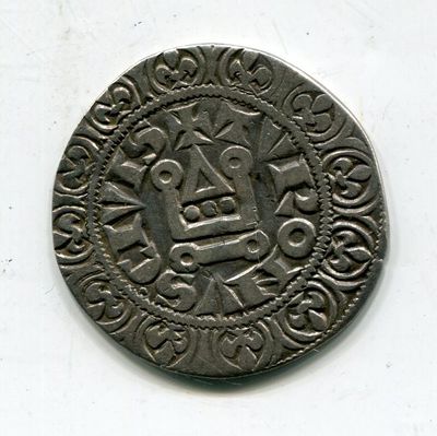 une vieille pièce d'argent sur laquelle figure le portrait d'un homme