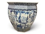 a blue and white vase sitting on a white surface