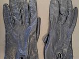 pair of black leather gloves sitting on top of a table