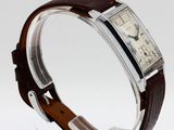 a close up of a wrist watch with a brown leather band