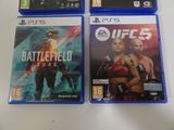 three video games are sitting on a white surface