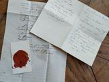 a close up of a piece of paper with a wax seal on it