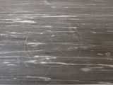 a black and white photo of a wood floor with a circle drawn on it