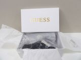 the contents of a white box containing a pair of black shoes