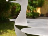 a bird shaped bowl sitting on the grass in the yard
