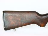 a close up of a rifle on a white surface with a white background