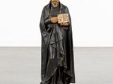 a statue of a man holding a book in his hands