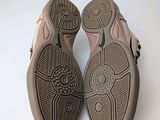 pair of women ' s shoes on a white surface with a white background