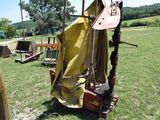 a yellow tarp covering a chair in a field