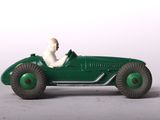 a green toy car with a man sitting in it
