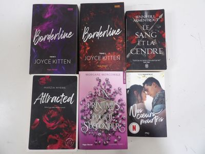 four paperbacks of romance novels sitting on a white surface