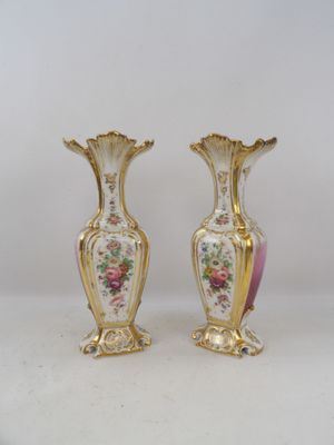 two vases that are sitting on a table