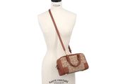 beige and brown handbag on mannequin torso with white background