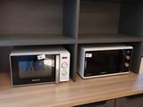 deux micro-ondes posés sur une étagère dans une cuisine