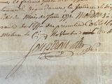 an old document with writing on it sitting on top of a table