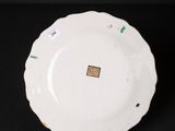 a close up of a white plate on a black surface