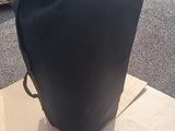 a black bag sitting on top of a cardboard box