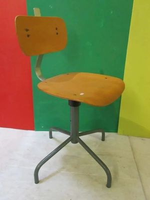 a chair that is sitting in front of a colorful wall