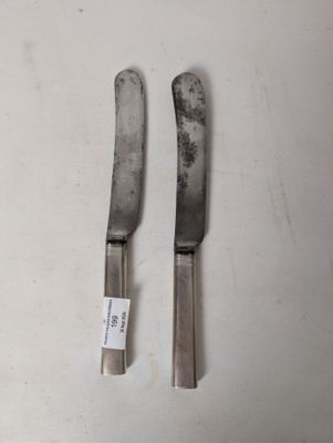 two knives that are sitting on a table