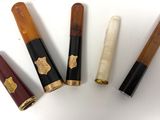 four different types of pens are lined up on a white surface