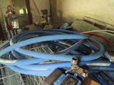 a pile of blue hoses sitting on top of a pile of other hoses