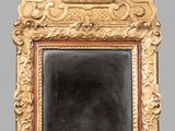 an image of a gold framed mirror on a gray wall