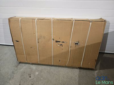 une boîte en carton posée par terre devant la porte d'un garage