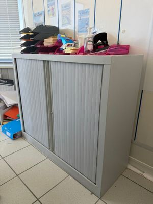 a cabinet that has a bunch of items on top of it