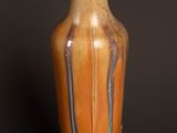 a vase that is sitting on a table with a black background