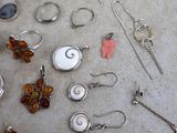 many different types of jewelry displayed on a table
