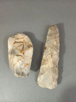 two pieces of stone on a table next to each other