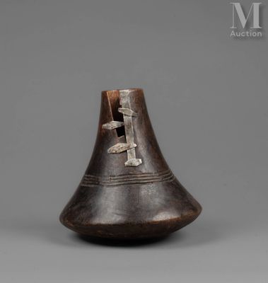 a close up of a vase on a gray surface with a gray background