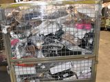 a large metal cage filled with assorted items in a warehouse