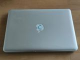 a laptop with a sticker on it sitting on a table