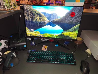 a computer desk with a monitor, keyboard, mouse and mouse