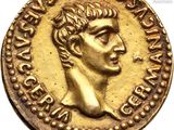 a close up of a gold coin with a man ' s face on it