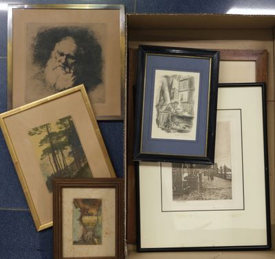 a box full of framed pictures and pictures on the floor