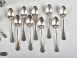 six spoons that are sitting on a table