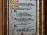 an old framed picture of a poem on a brick wall
